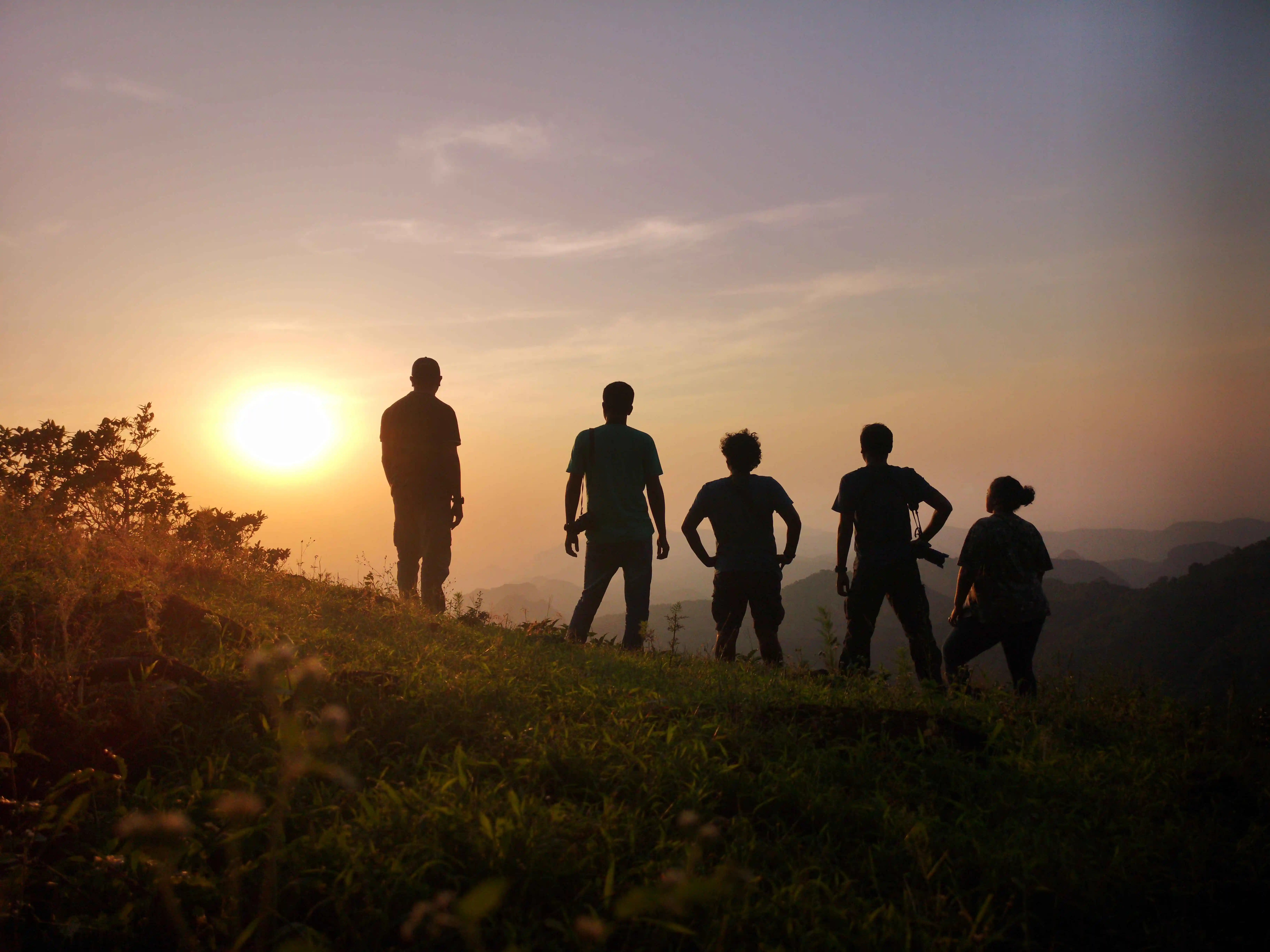Guests silhouetted against a Satpura sunset