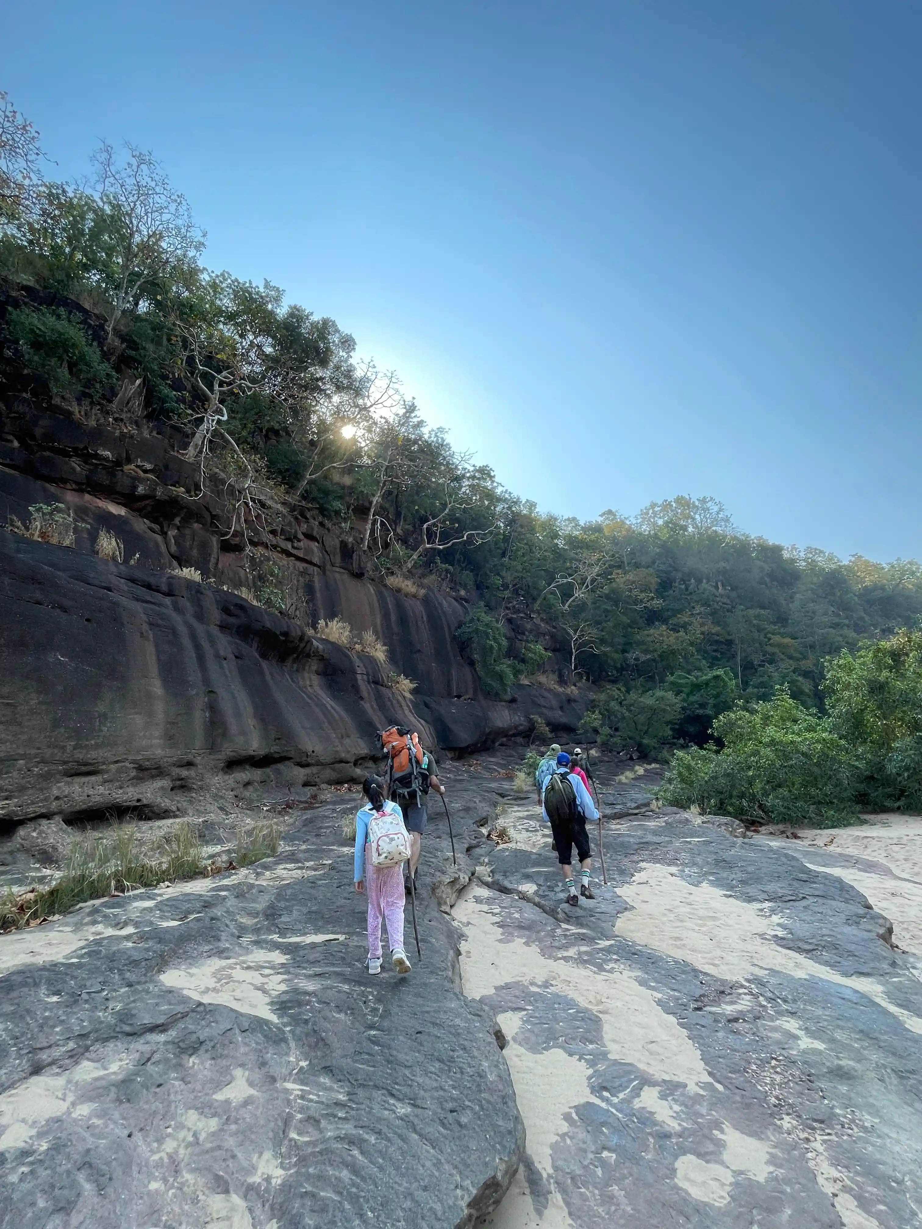 Guests hiking across Satpura rock formations